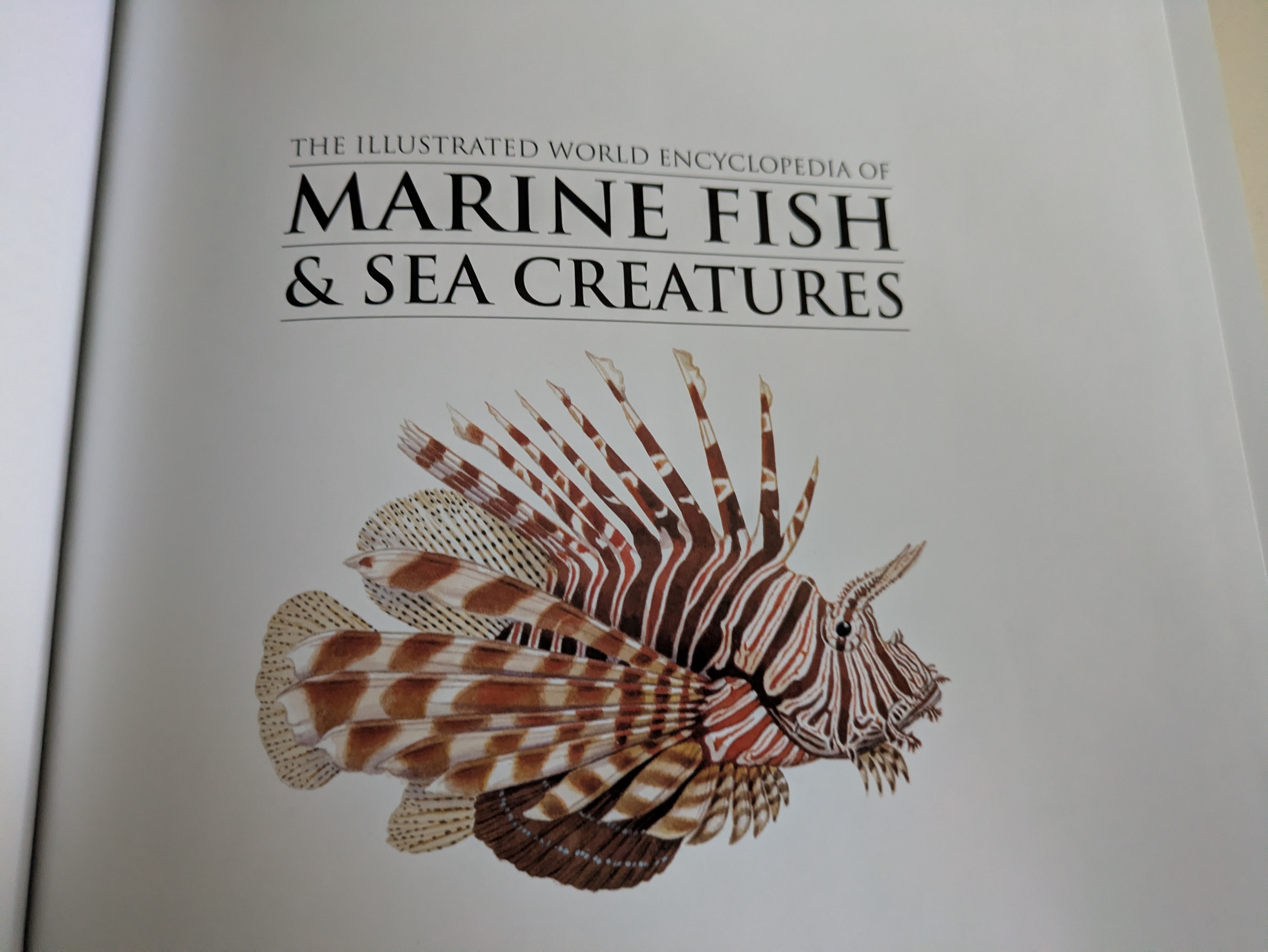 The title page of the encyclopedia, featuring a detailed illustration of a lionfish — one of the most visually striking species in the marine world.
