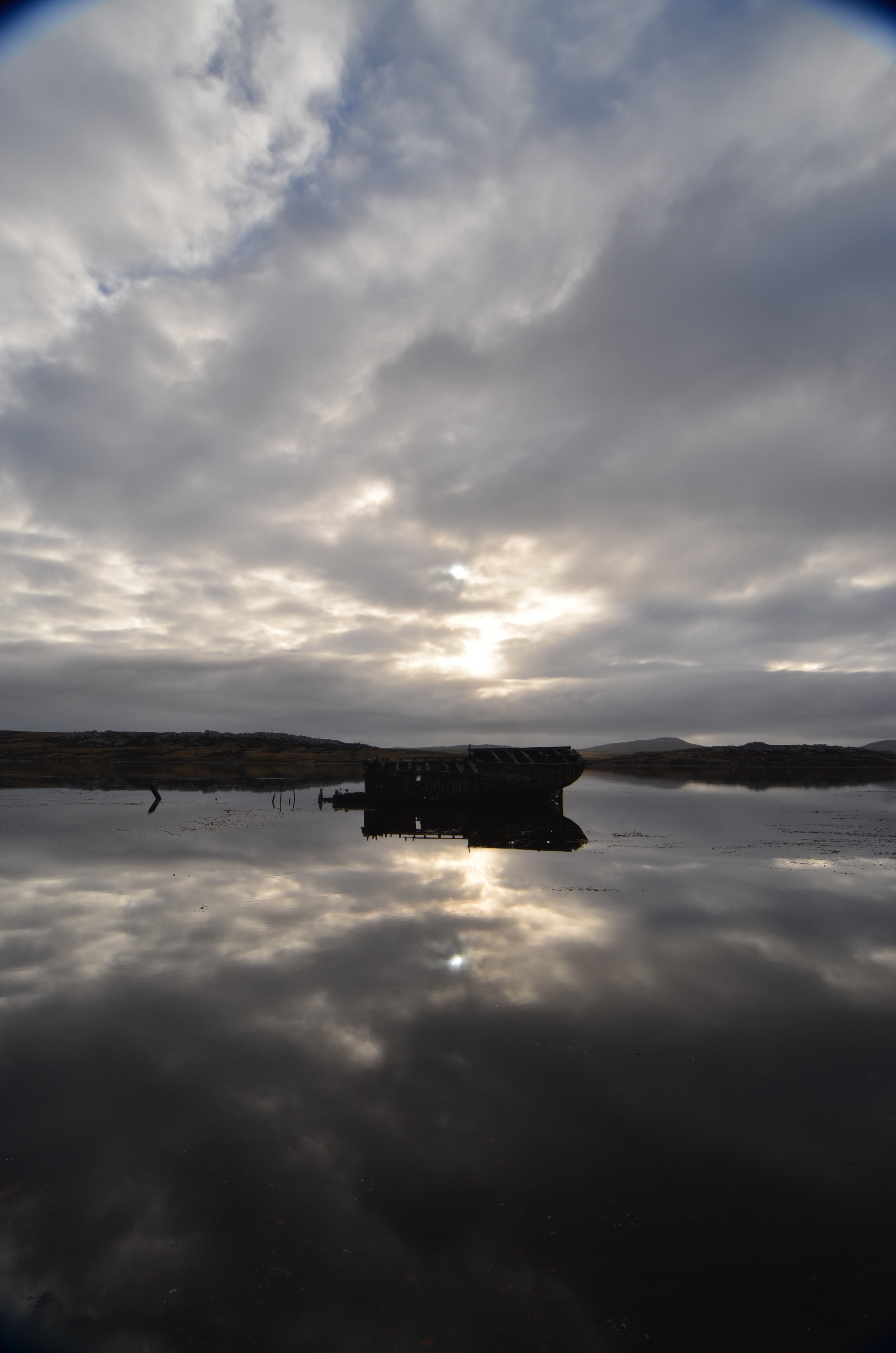 Shipwreck silhouette and reflections at Port Stanley in the Falkland Islands